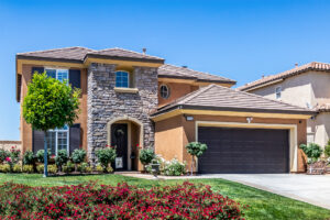 1 Front of a home showing entry way with green grass and a blue sky in the background