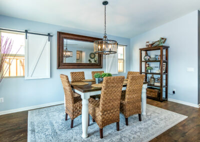 Dining area with custom chandelier, wicker chairs, mirror, and wood floors, tyler media works, real estate photography