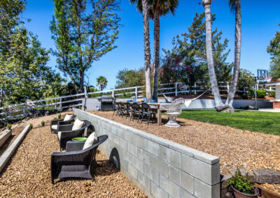 Backyard seating area with gravel and retaining wall, tyler media works, real estate photography