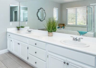 Bathroom with white cabinets and mirror, tyler media works, real estate photography