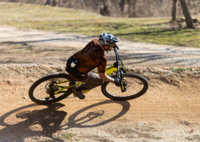 mountain biker going over around a berm