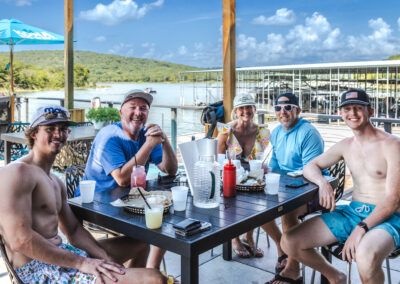 people at a table with the lak in the background